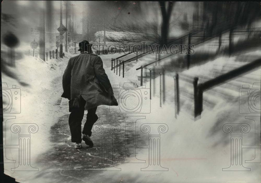 1962 Press Photo Man walking in the snow, Milwaukee, Wisconsin - mjc18195 - Historic Images