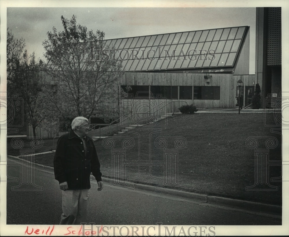 1979, Mr. Hanson walks near Wisconsin's first solar heated building - Historic Images