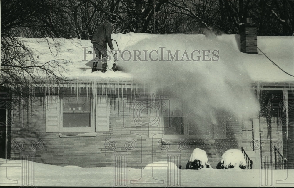 1979 Thomas Boucher clearing snow from his roof, Wisconsin - Historic Images