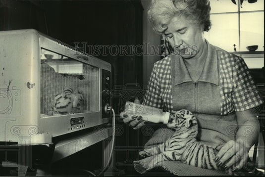 1983 Press Photo Jean Rhodes bottle-feeds a white tiger cub at Racine Zoo - Historic Images