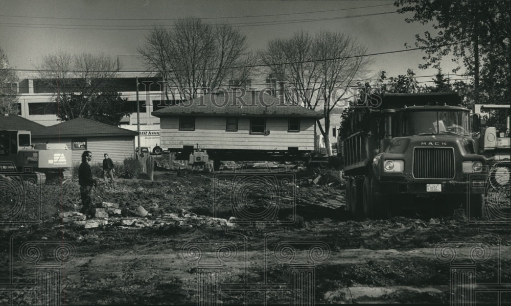 1992, Workers move home for Trinity Hospital parking area, Cudahy. - Historic Images