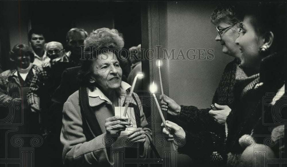 1989, People lighting candles Trinity Memorial Hospital, Wisconsin. - Historic Images