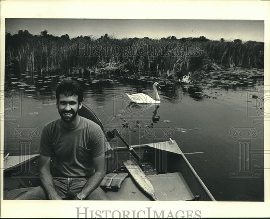 1987, Male swan kept an eye on Dave Matheys of the DNR - mjc18910 - Historic Images