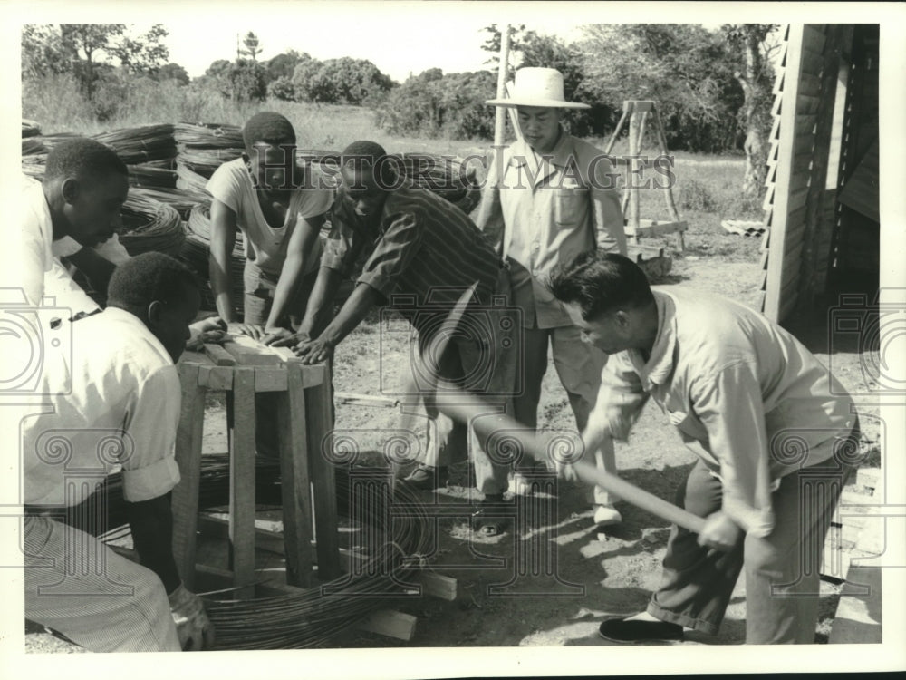 1972, Tanzanians Work Construction While Chinese Supervisor Helps - Historic Images
