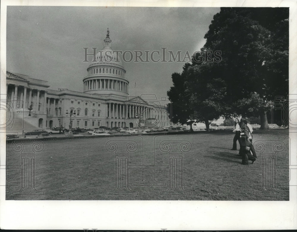 1975 Karin Tills toting school books across US Capitol - Historic Images