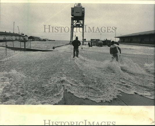 1983 Mike Sendeoj and Gene Kopacz on Jones Island as waves come in - Historic Images