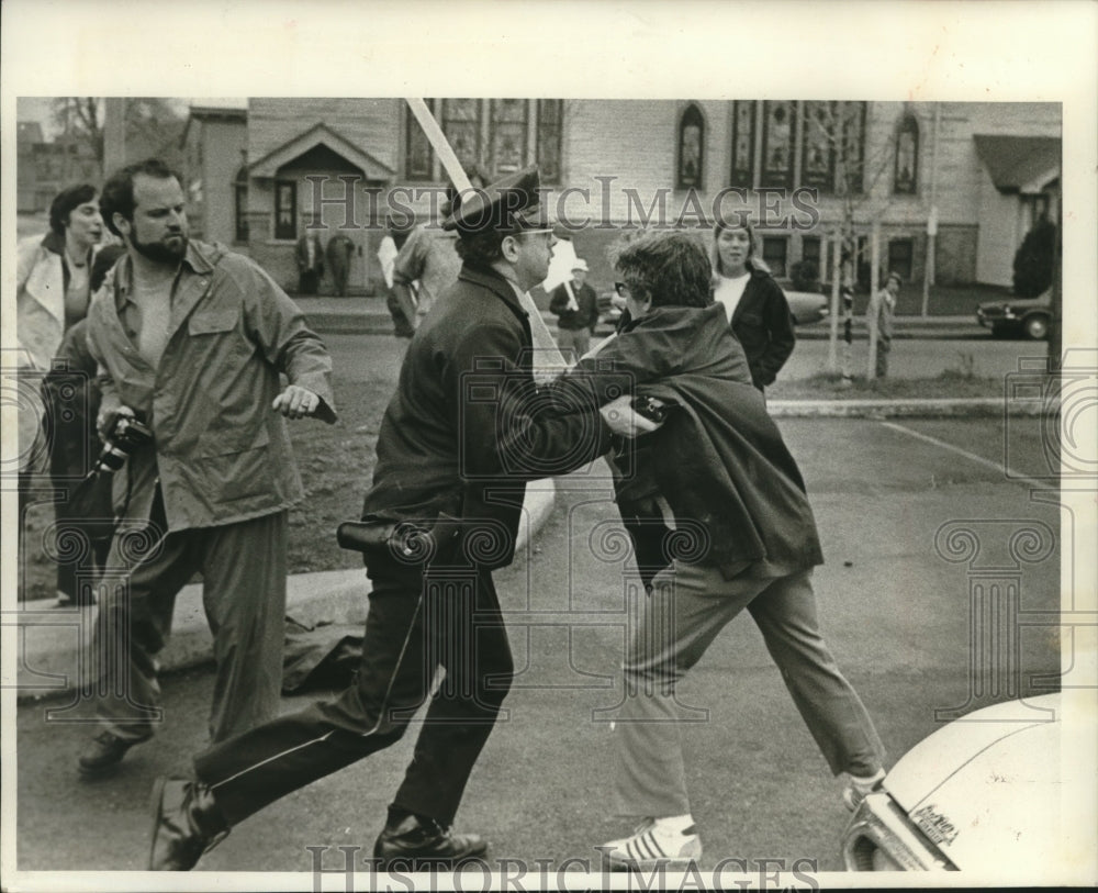 1977, Policeman scuffled with a picket outside a Milwaukee school - Historic Images