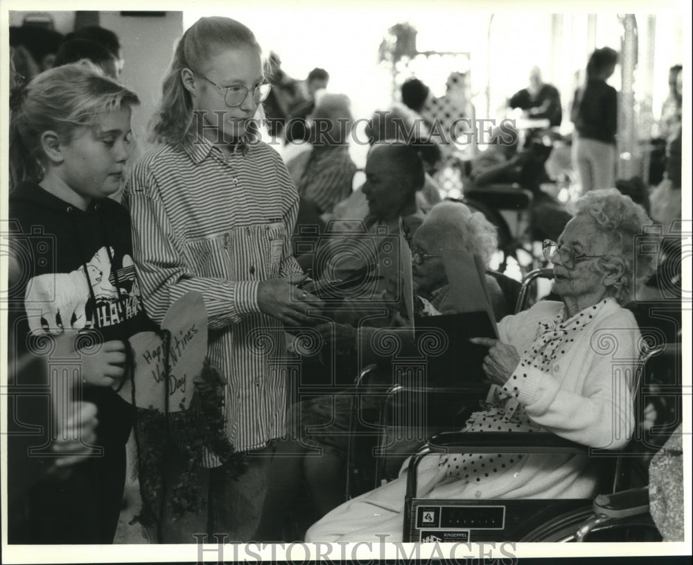 1995 Ashley Skoug and Lexi Dickert give Valentines to Karen Olson - Historic Images
