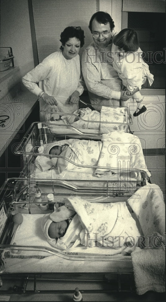 1988, Mark Schaus, wife, daughter with new triplets, Milwaukee. - Historic Images