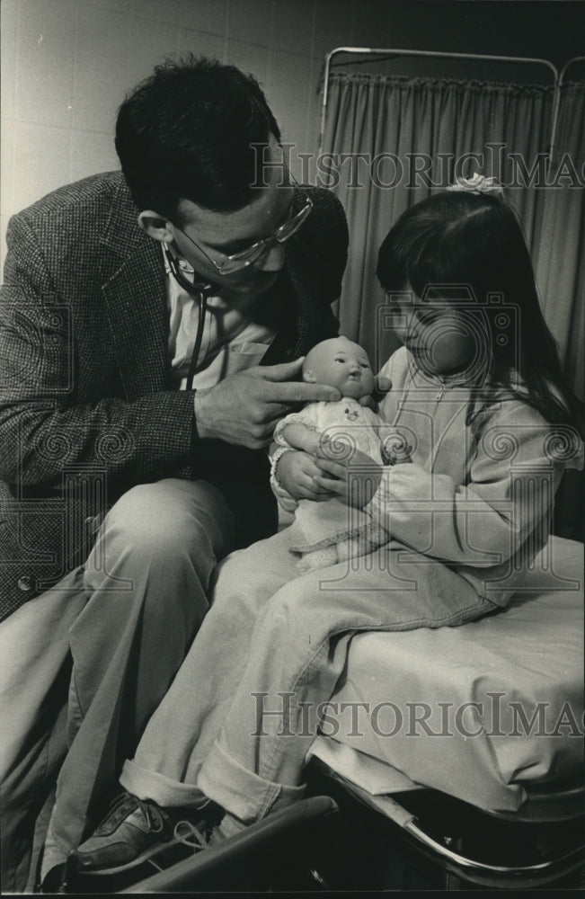 1989, Doctor Tim Buchanan Does Checkup on Erin Petrus' Doll in Cudahy - Historic Images