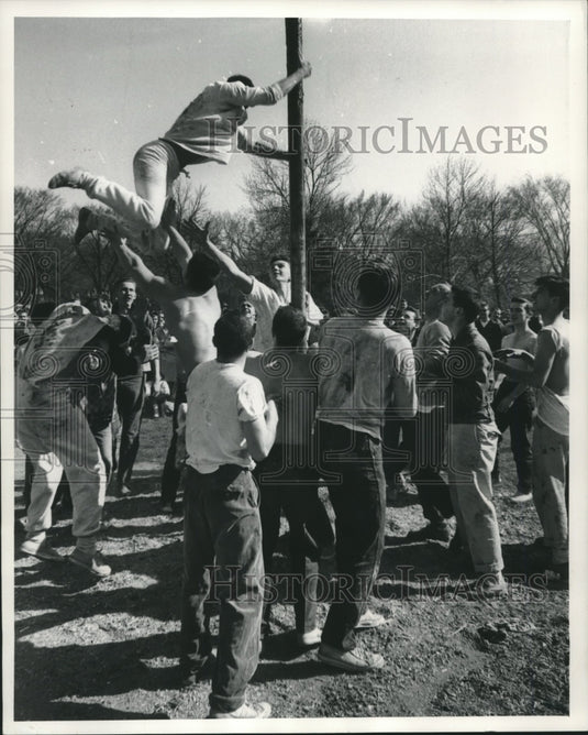 1981, Men, University of Wisconsin, Milwaukee climb greased pole - Historic Images