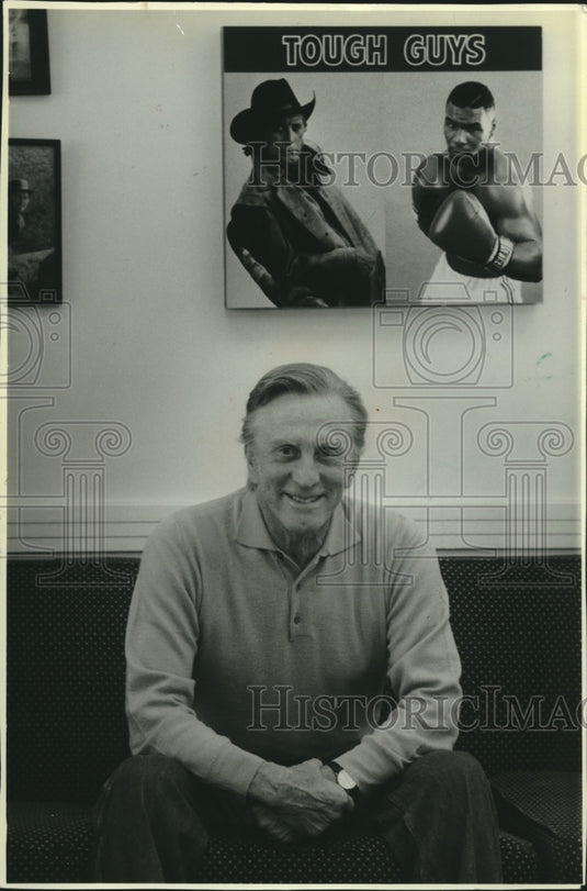 1988 Press Photo Actor Kirk Douglas sits beneath photo of himself & Mike Tyson - Historic Images