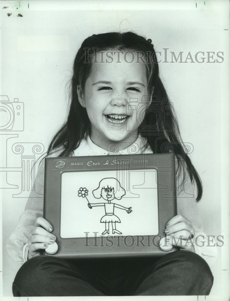 1986 Child holding the classic Etch A Sketch toy.-Historic Images