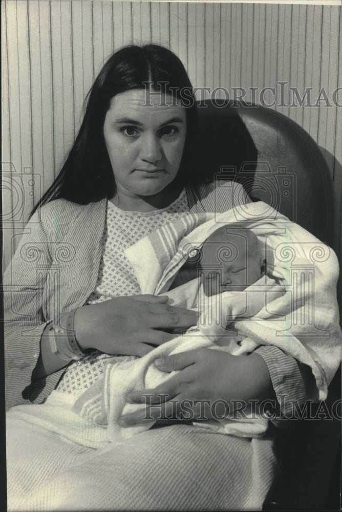 1986, Karyn Tess holding son at County Medical Complex, Wauwatosa. - Historic Images