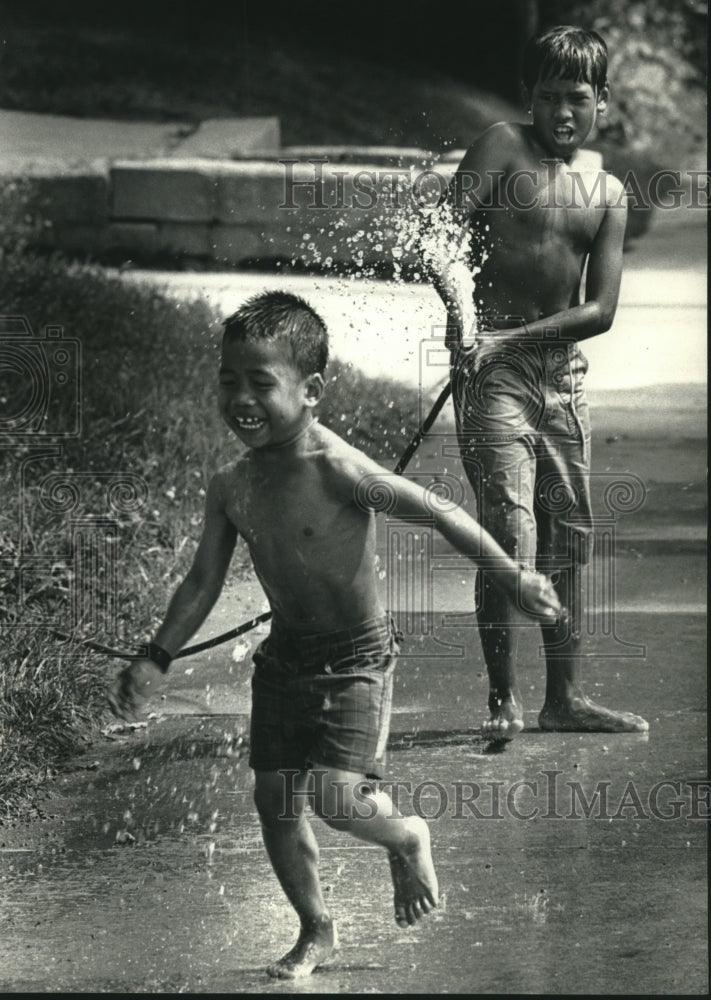1992, Children Playing in Water on Hot Day in Milwaukee, Wisconsin - Historic Images