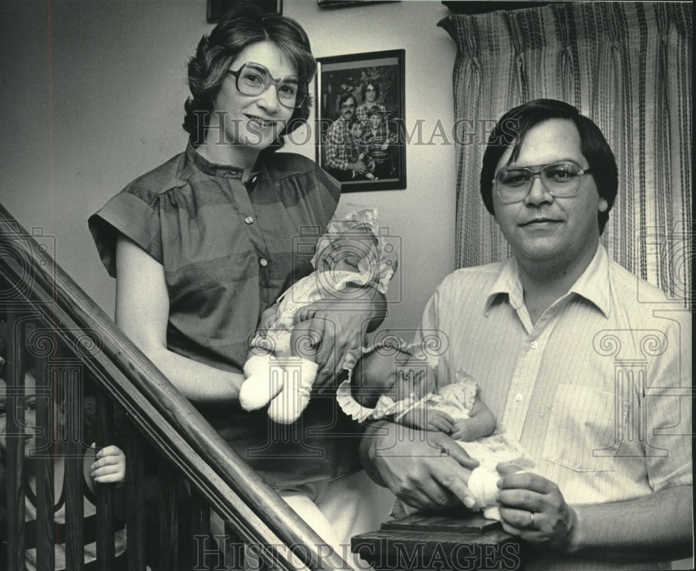 1984, Barb, Ken Hasner hold twin daughters who were Siamese Twins - Historic Images
