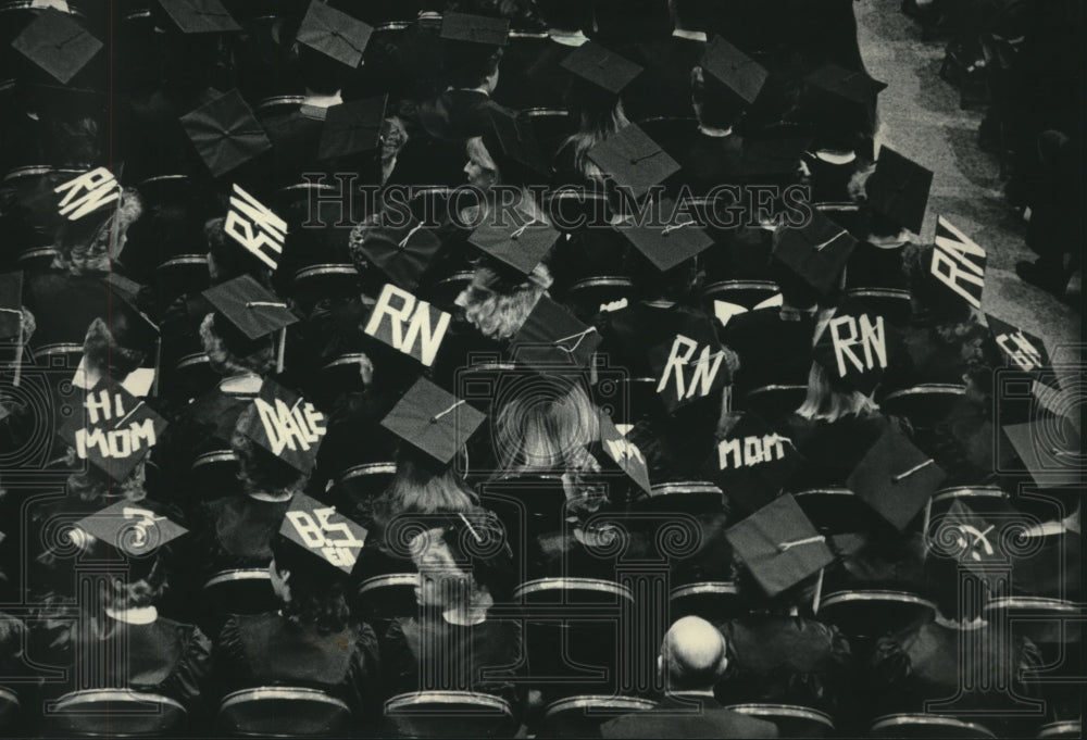 1984, Students UWM graduation show feelings with hat signs, Wisconsin - Historic Images