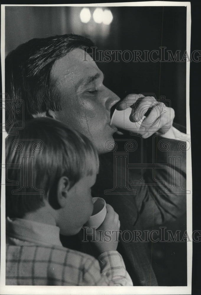1977, Martin Schreiber, son Matthew, taking a drink, Wisconsin - Historic Images