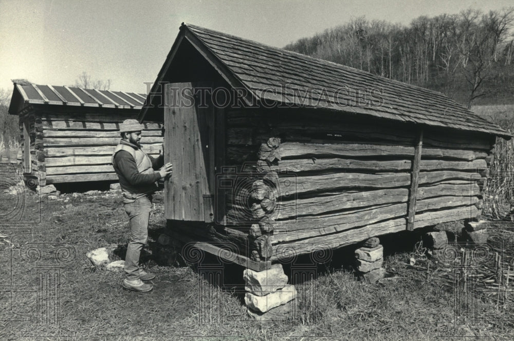 1983, Robert Swartz at a restored corncrib, Norskedalen, Wisconsin - Historic Images