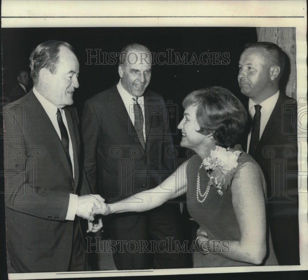 1967, Onlookers watch VP Humphrey shake hands with Mrs. Nelson. - Historic Images