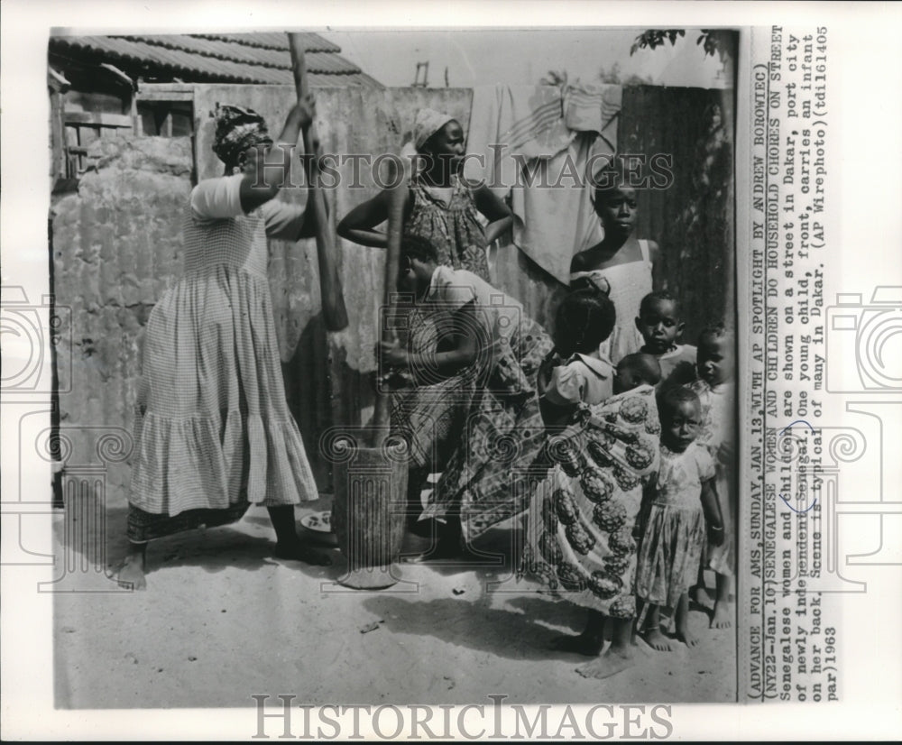 1963 Press Photo Senegalese women and children do chores, street in Dakar - Historic Images