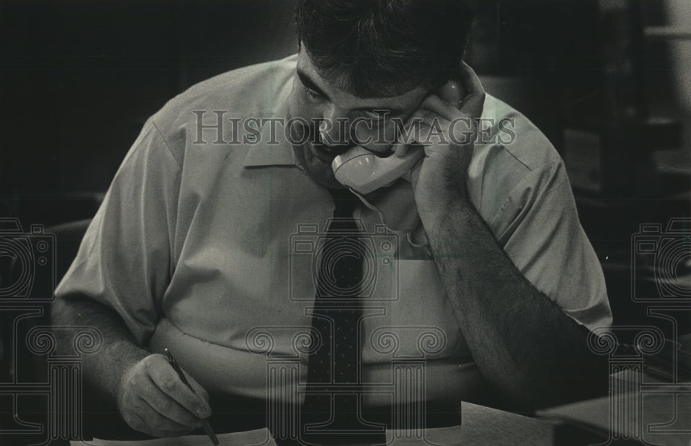 1987, County Executive David F. Schulz on the telephone in his office - Historic Images