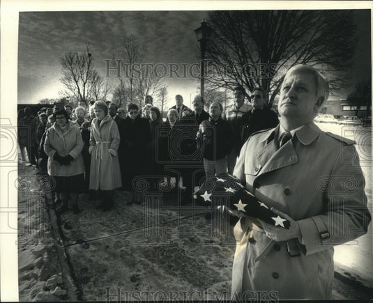 1991, Mayor James A. Brundahl holds flag for Marine Scott Schroeder - Historic Images