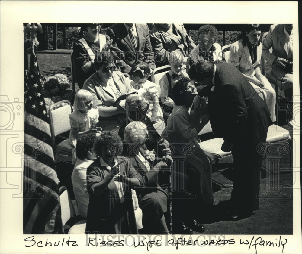 1988, David Schulz kisses wife with family at inauguration, Milwaukee - Historic Images