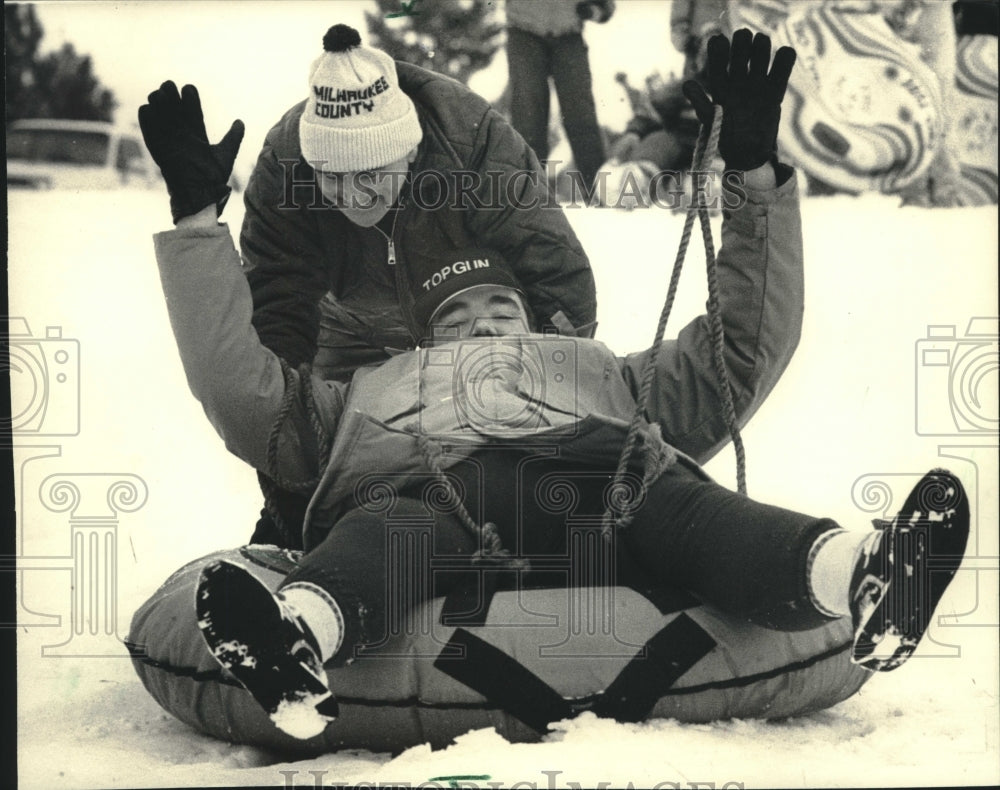 1987 County Parks Director David Schulz snow tubing, Wisconsin - Historic Images