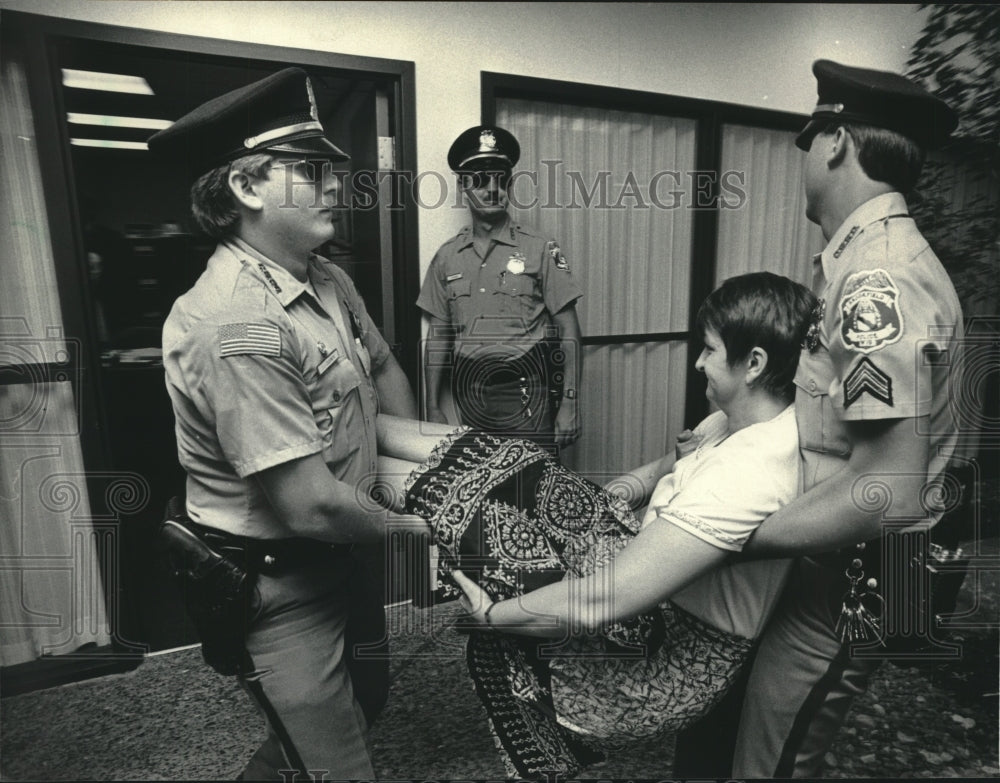 1985, Brookfield Police Carry Protester at James Sensenbrenner Office - Historic Images