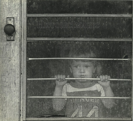 1982, Tough Times Series -- Bo Bissonnette peers from front door - Historic Images