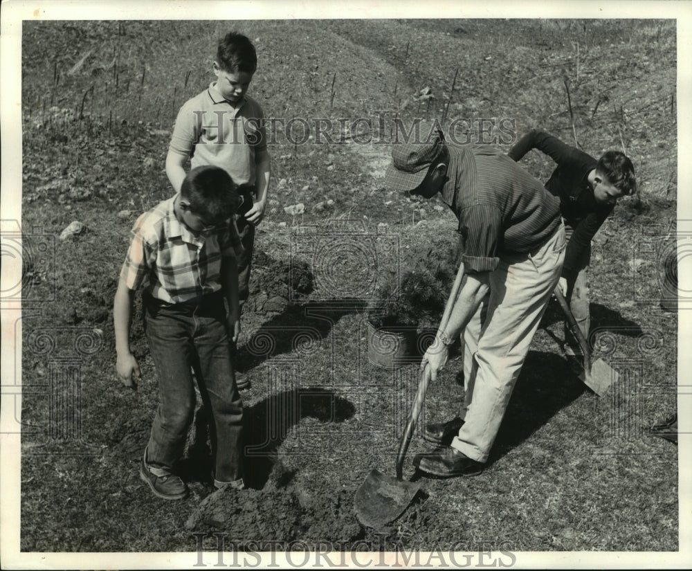 1960, Adult demonstrating tree planting to students - mjc21736 - Historic Images