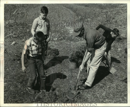 1960, Adult demonstrating tree planting to students - mjc21736 - Historic Images