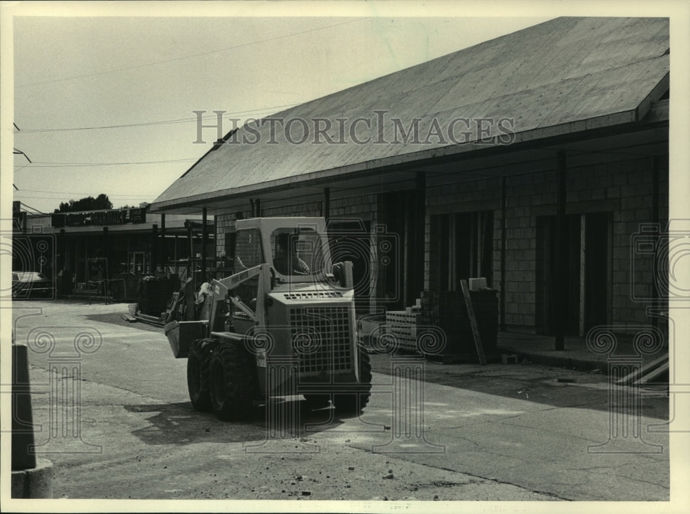 1985 A front end loader moves through Thiensville construction site - Historic Images