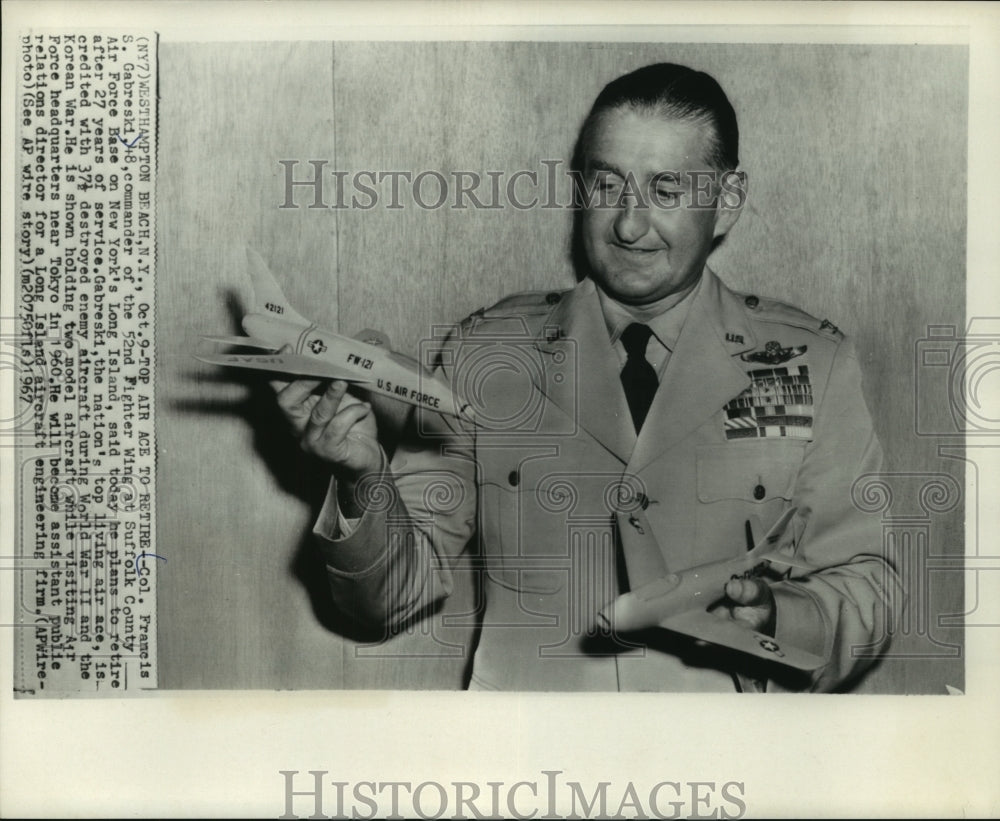 1967, Colonel Francis S. Gabreski shows models of a two planes. - Historic Images