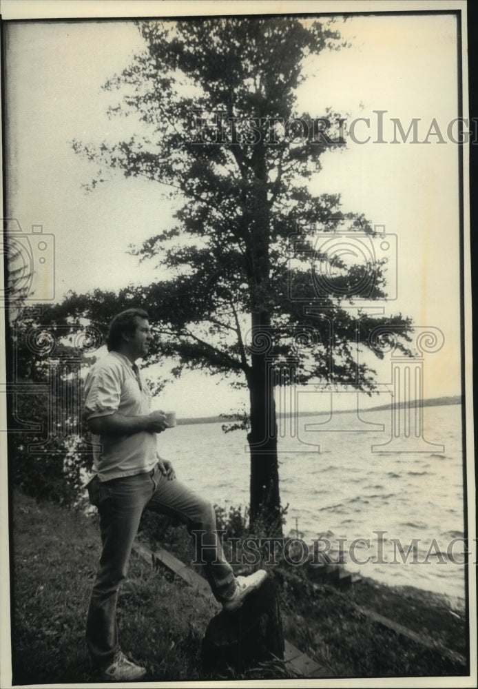 1992, Dave Puetzer at Pewaukee Lake next to a European alder tree - Historic Images