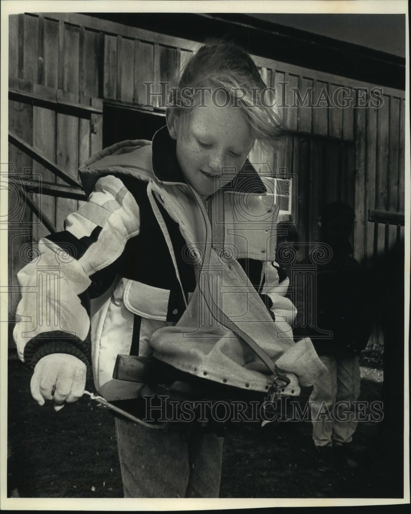 1992 Jessica Delaney uses old-fashioned seed spreader, Trimborn Farm - Historic Images