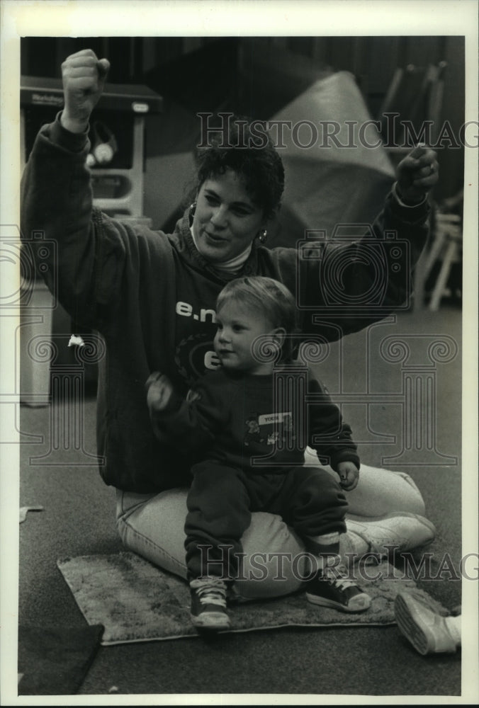 1993 Laurie Grahl, a teacher at The Threshold, sits with a child - Historic Images