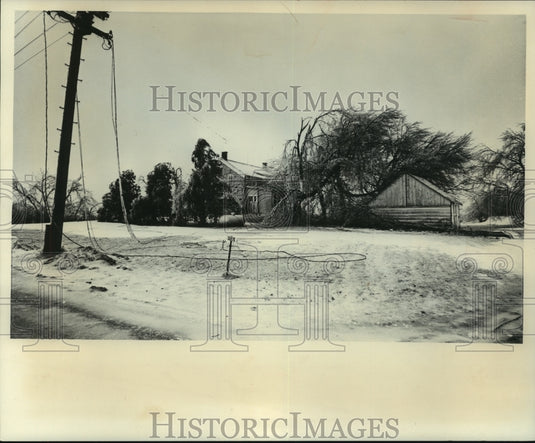 1976, Power lines were down in front of a Wisconsin farm after storms - Historic Images