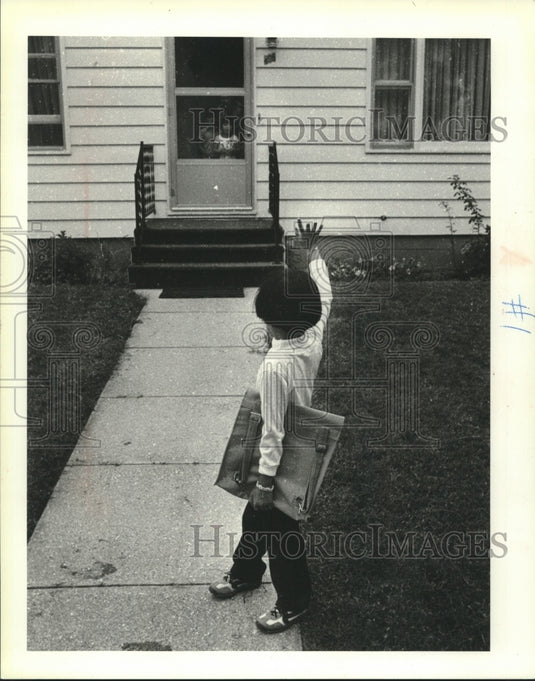1980 Rathana Ung  waves goodbye as she heads to school - Historic Images