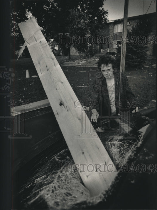 1992, Tornado blew board through windshield of Elaine Humphrey's car - Historic Images