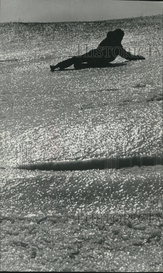 1976 Child sliding down icy hill in Grafton, Wisconsin - Historic Images