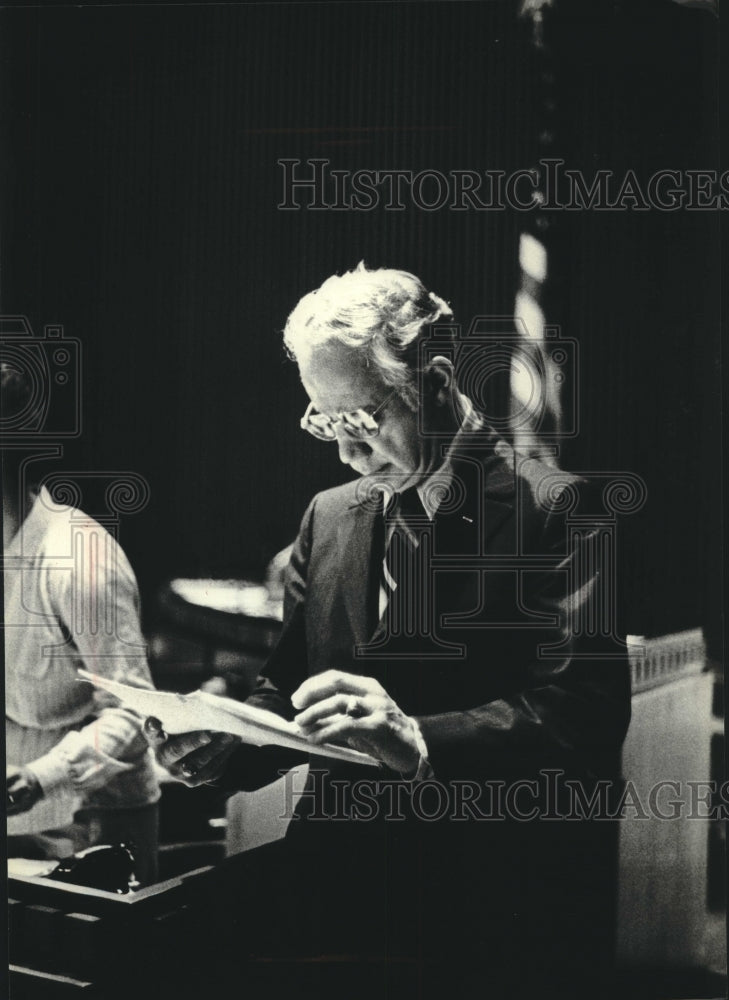 1979, Judge Christ T. Seraphim Checking Records of Case in Courtroom - Historic Images