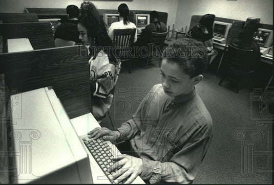 1991, Orlando Haliga on the computer at the United Community Center - Historic Images