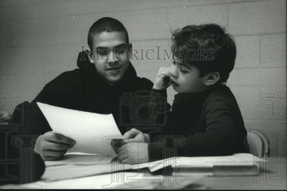 1994 Enrique Ramirez tutors Dorian Gailan at United Community Center - Historic Images