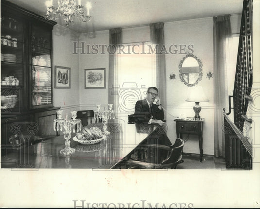 1965, Lawrence O'Brien, U.S. Postmaster General, takes a call at home - Historic Images