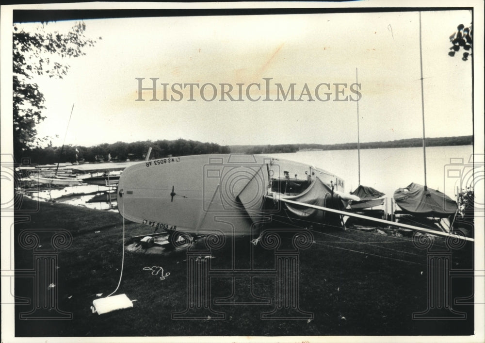1992, Sailboat was blown over at a home on Pewaukee Lake, Wisconsin - Historic Images