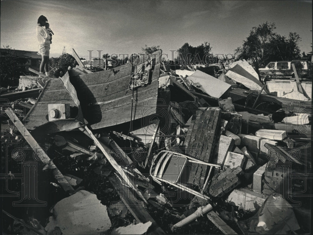 1992 Tim Wittmann and son look over tornado damage in Wabesa Heights - Historic Images