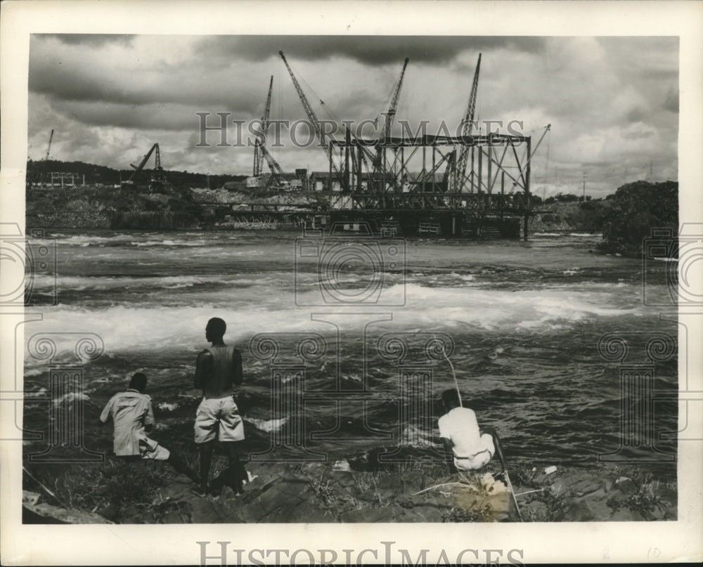 1952, Native fishing near hydroelectric plant construction, Uganda - Historic Images