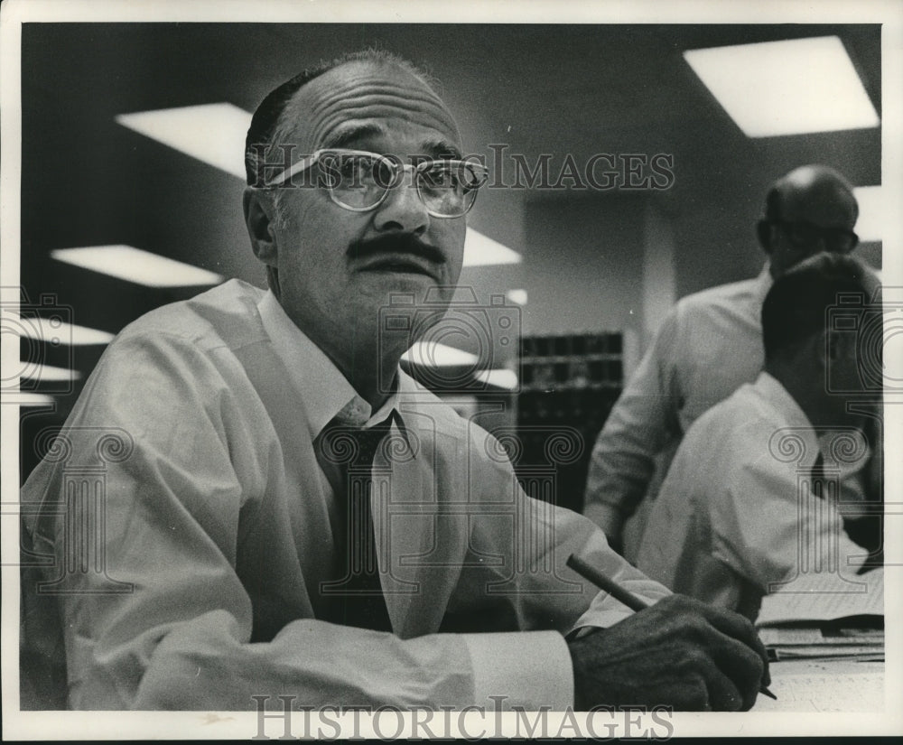 1968, Rod Van Every, Journal employee, writing at his desk. - Historic Images